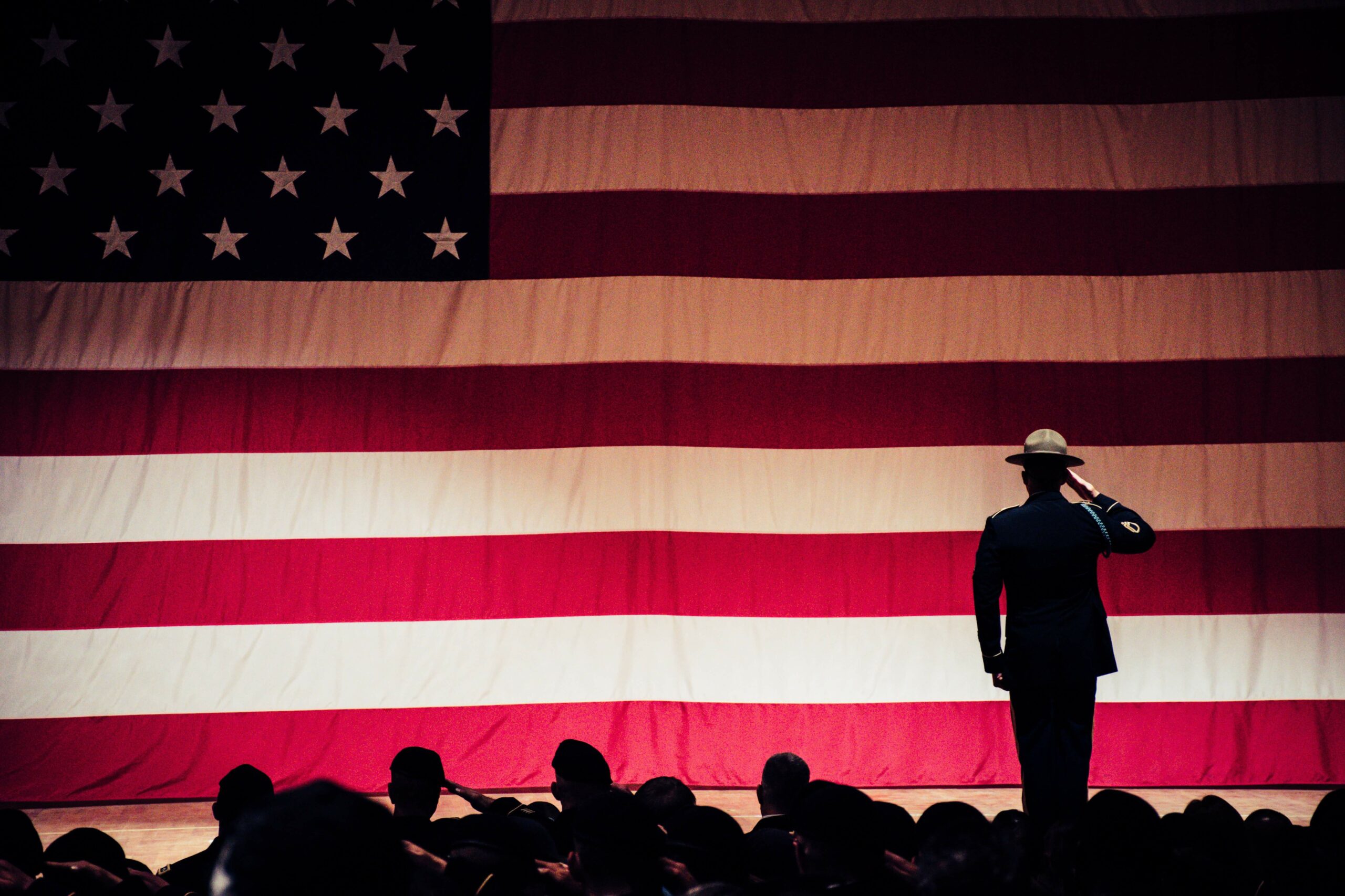 soldier saluting in front of flag